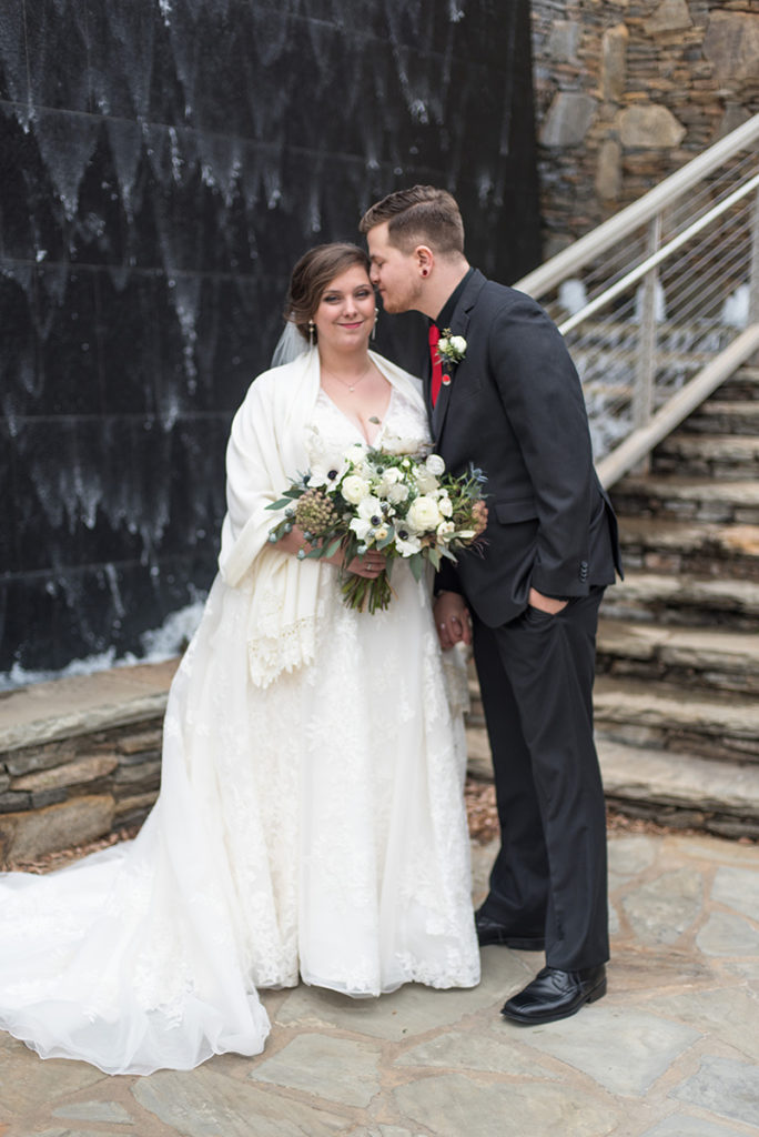 A bride in Groom share a kiss in Downtown Greenville, SC 