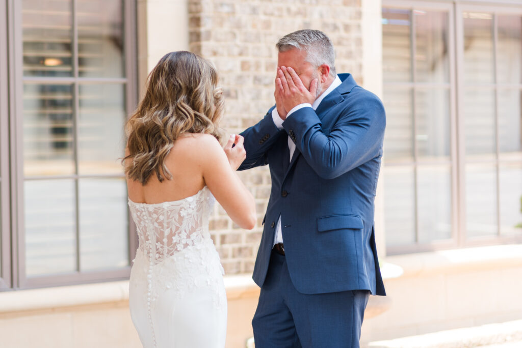 A bride's father tearing up during their first look at the bleckley inn