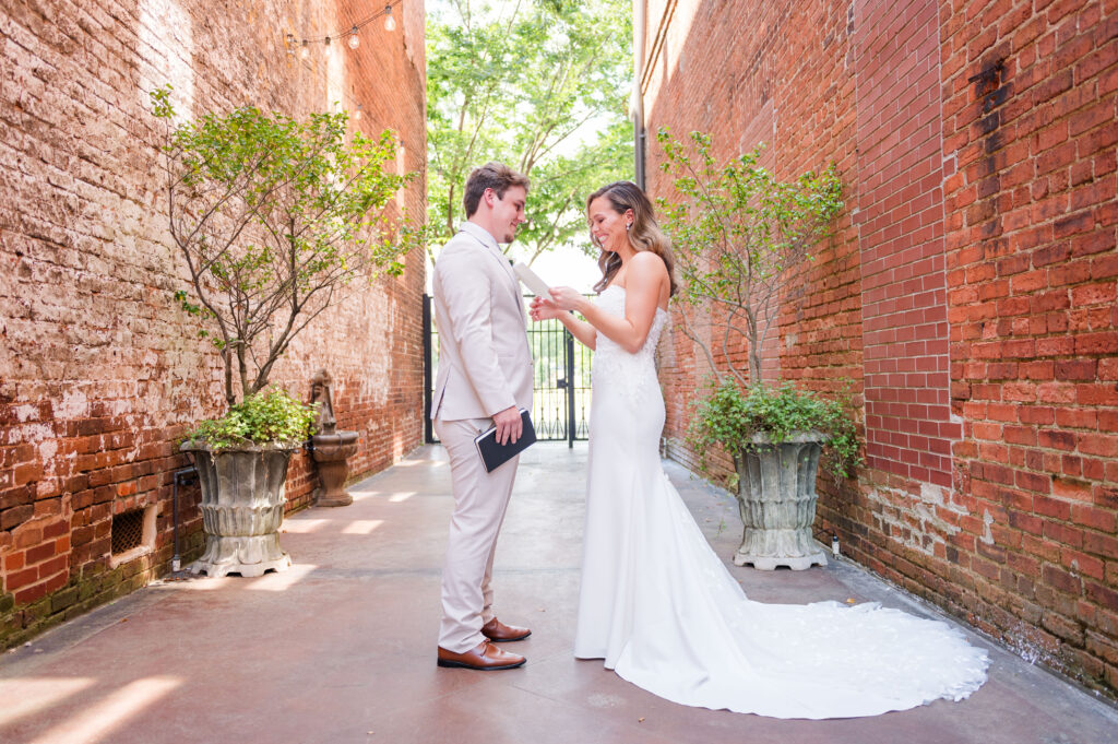 A couple shares private vows at the courtyard of the bleckley inn in the alleyway